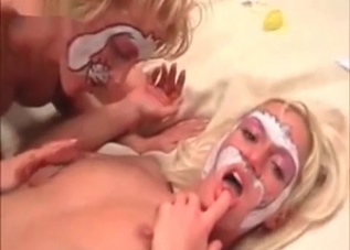 Hot ladies are kissing a puppy wildly